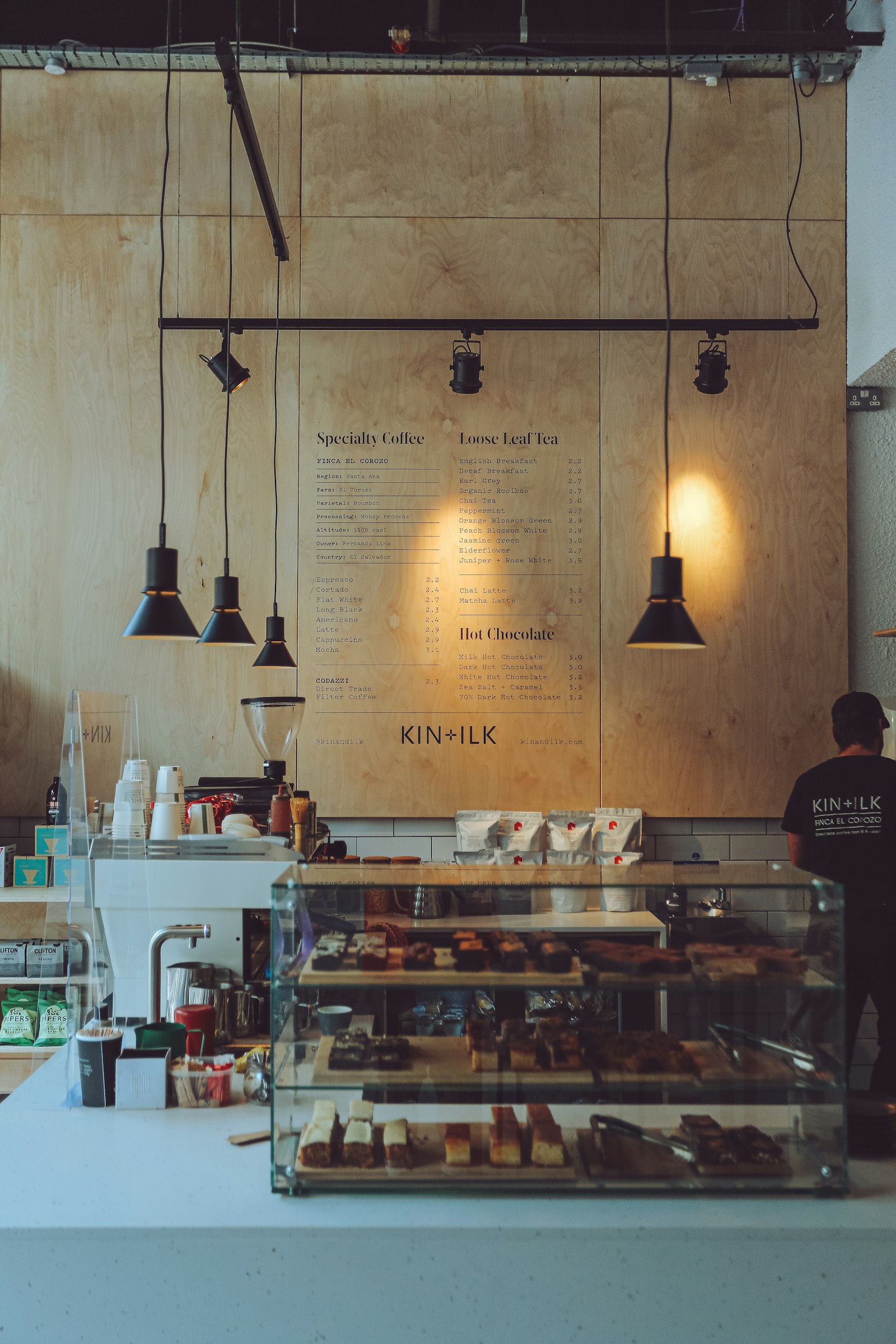 Coffee shop service counter with plywood menu wall