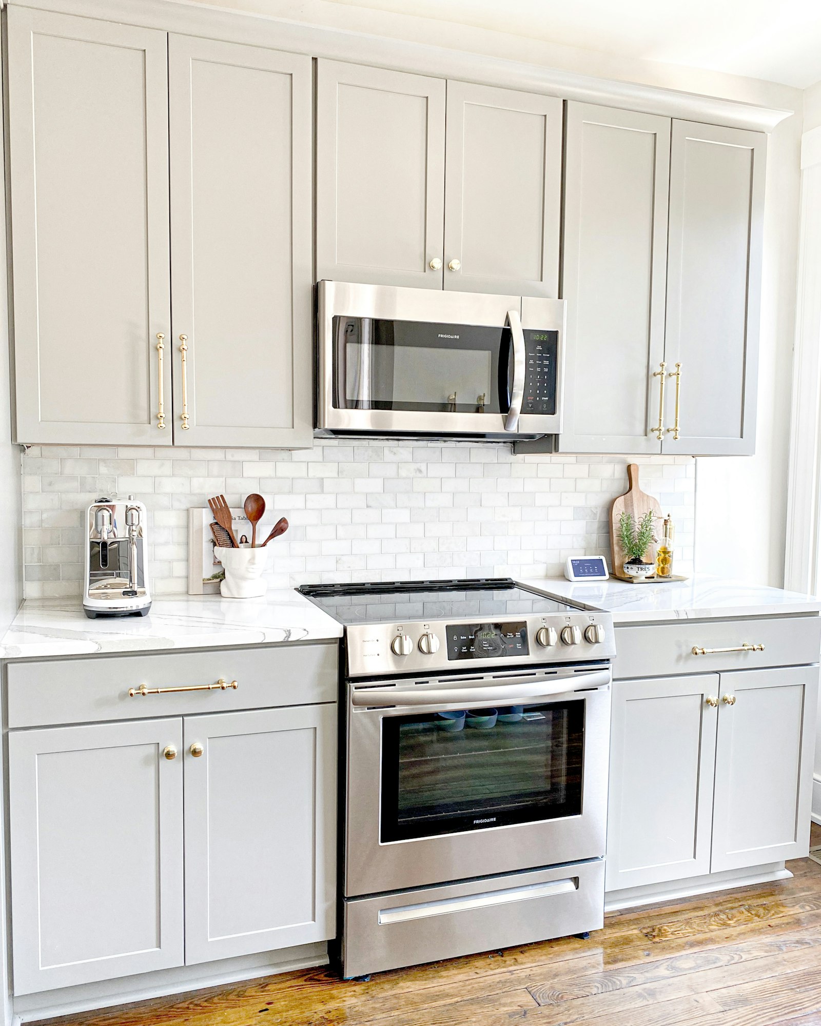 Gray shaker cabinets with marble backsplash