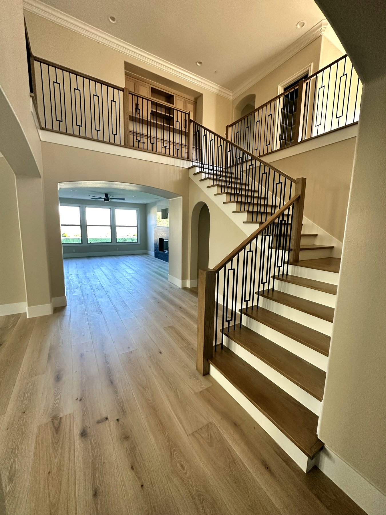Grand foyer staircase with custom millwork