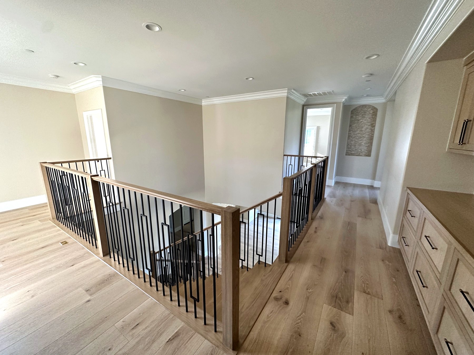 Upstairs landing with wood cap rail and crown molding